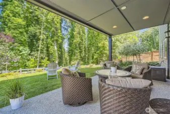 Lovely outdoor area off the basement level living quarters. Retractable sun-shade also installed.