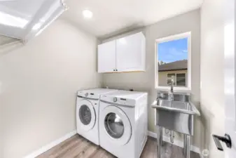 spacious laundry with custom stand alone sink added