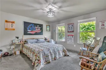 Relax and recharge in the spacious primary bedroom.