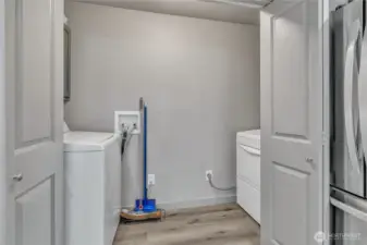 Laundry room with built-in cabinetry.