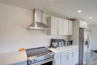 Kitchen has been updated and has quartz counters and stainless appliances.