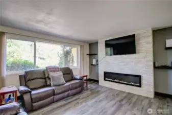 Living room with stylish rockery with electric fireplace.