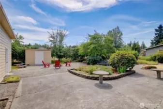 Back of home with private pathways through mature landscape.