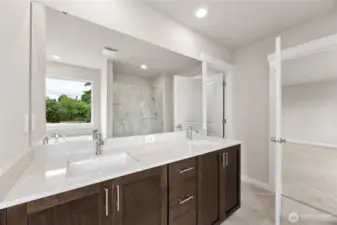 Large double vanity as part of 5-piece primary bathroom with quartz countertops and soft close cabinets. Actual home is under construction and finishes, materials, and colors will vary. See site agent for details.
