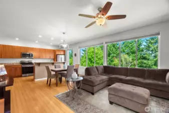 Wow! Open and bright living, dining and kitchen, with sturdy bamboo flooring and a bank of large windows to bring light and nature in