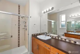 Beautiful tile accents in the primary bath, large reed glass window for both light and privacy