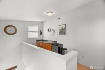 This loft/landing space serves the rooftop deck an is the perfect launching spot for some epic entertaining! Small refrigerator can be included in the sale