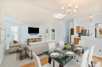 Bright and open living room featuring new carpet, fresh interior paint, and large windows that fill the space with natural light. The modern open-concept layout connects seamlessly to the dining and kitchen areas, ideal for everyday living and entertaining. (Virtually Staged)