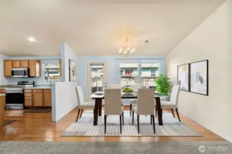 Spacious dining area located just off the kitchen, perfect for family gatherings or casual meals. Updated lighting and neutral tones create a warm and welcoming atmosphere in this Mount Vernon rambler. (Virtually Staged)