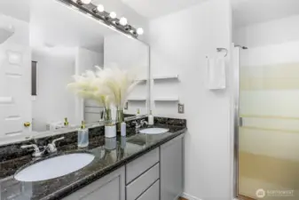 The primary bathroom features a double-sink vanity and a walk-in shower.