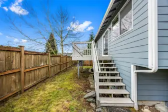 The fully fenced backyard offers privacy and room to play, with a deck perfect for outdoor entertaining.