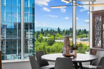 19th floor residence with sweeping city skyline, water, and mountain views from expansive windows.