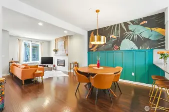 The dining area features an upgraded light fixture and a striking wallpaper, an eye-catching focal point full of personality.