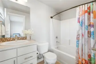 The well-appointed secondary bathroom provides  comfort and privacy for guests or shared  living.