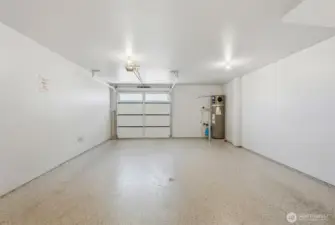 Extra-deep 2-car tandem garage upgraded  with epoxy flooring, insulation and finished  walls.