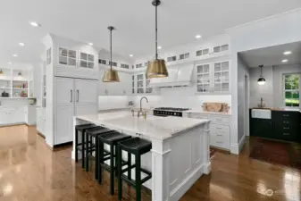 Chef's kitchen with custom cabinetry, real quartzite countertops, LaCornue double stove/range, sub zero, unlacquered brass fixtures, walk-in pantry and wet bar/butler's pantry.