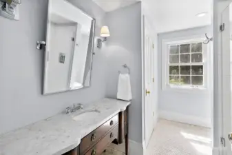 En-suite bath off the 5th bedroom is graced in marble.