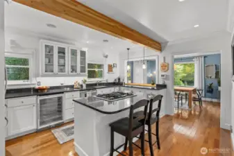 A home chef's dream kitchen! Includes a wine fridge, gas range with downdraft exhaust, impressive counter space and a pass through perfect for entertaining.