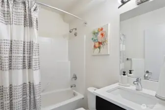 Entry level full bathroom with modern finishes.