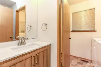 Lower level half bath and door to laundry room