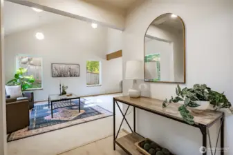 Entry flows into living room that is open to the second floor