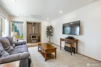 Bright cheery informal living space with fresh paint and free standing wood stove