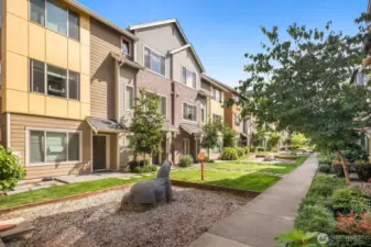 Courtyard features green space and play zones.