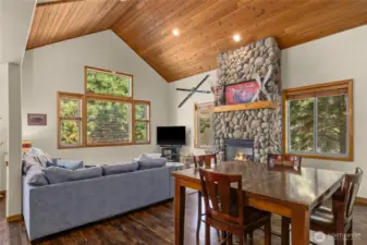 Great Room and dining space. Stone fireplace and vaulted ceilings
