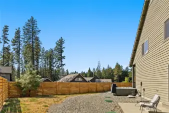 Back of home with private patio for primary bedroom
