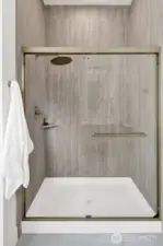 The primary  bathroom also features a spacious walk-in shower