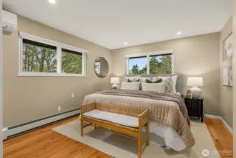 Primary Bedroom on Main easily accommodates a king bed plus side tables. Note the mini-split to help you sleep more comfortably during the hottest days of the year.