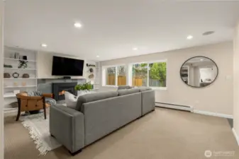 Lower Level Family/Media Room will be one of your favorite spaces...easily fits a large amount of seating for movie night or game day and TV stays! With the surround sound system, you'll never want to go to a theater again! Tons of natural light, view of the sport court and access to the covered patio with its own gas fireplace. There's also a large storage closet- this is a must see!