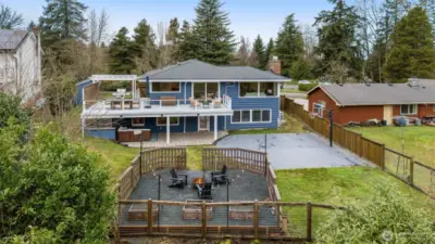 An aerial view of the back of the home and upper lot.