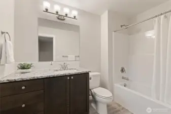 Primary Bedroom Ensuite Bath - featuring spacious vanity with storage, stone countertop, under-mount sink & tile backsplash.