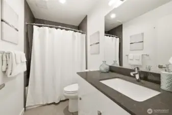 Full bath on the first level, just outside of bedrooms 2 and 3.