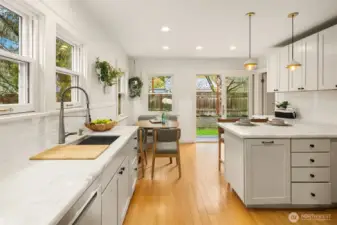 Marble countertops and shaker style cabinets give this kitchen a fresh modern feeling