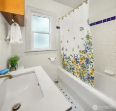 Bathroom features vintage tiles and bath and an old fashioned laundry chute