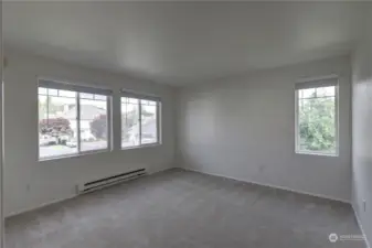 Bedroom with many windows creating plenty of natural light flowing through the room.