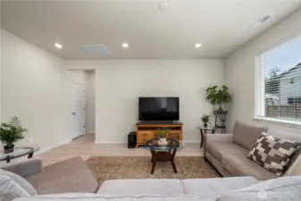Living room with view of hallway to primary