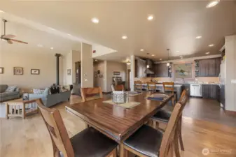 Hardwood floors lead into the kitchen spaces.