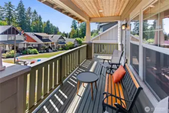 The front porch overlooks a well-maintained common area with patio.
