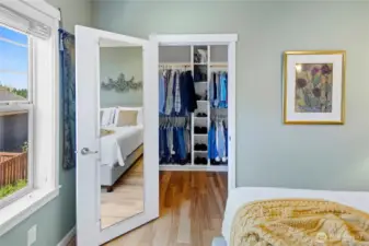 Primary bedroom with walk-in closet and full length mirror.