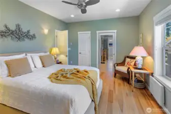 Primary bedroom with smaller closet at left and entry to bath at right.