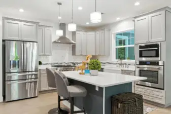 Chefs kitchen has granite slab countertops with full height ceramic or glass tile backsplash.
