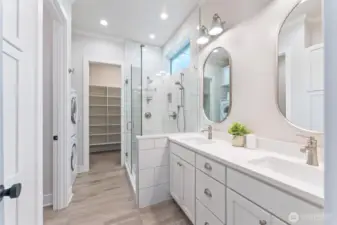 Primary bathroom with oversized walking closet and washer/dryer.
