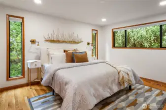 The spacious primary suite is on the main floor, includes dual closets, and has plenty of room for a king-sized bed.