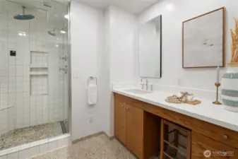 The primary bathroom is outfitted with a steam shower and heated floors.