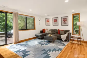 The bright and cheery family room on the lower level is perfect for movie nights and Seahawks games, with built-in surround sound speakers included!