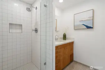 The ensuite bathroom on the lower level, also equipped with heated floors.