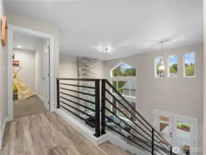 The grand stairwell has sleek metal railings.